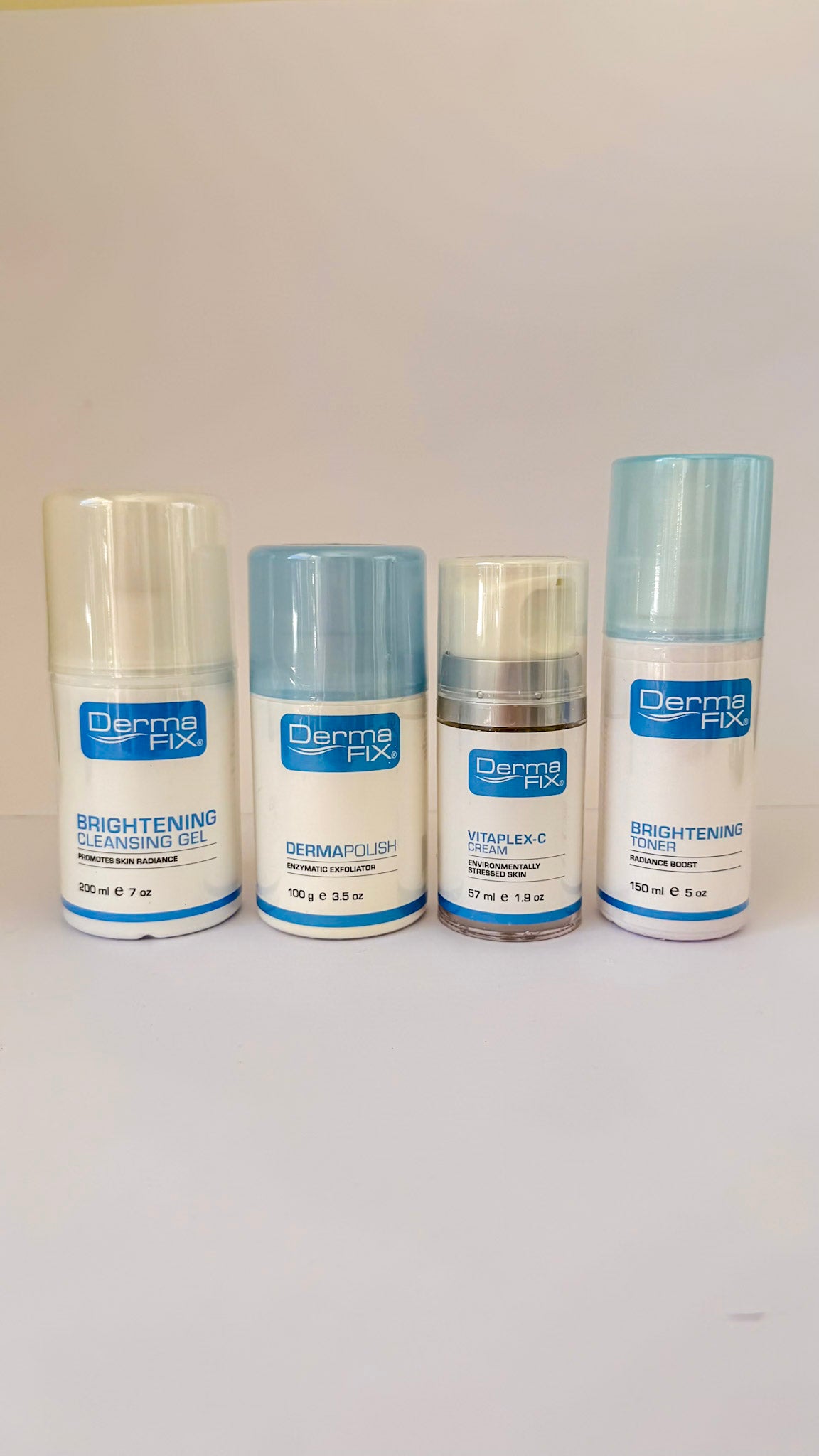 Four bottles of Derma Fix skincare products on a white background