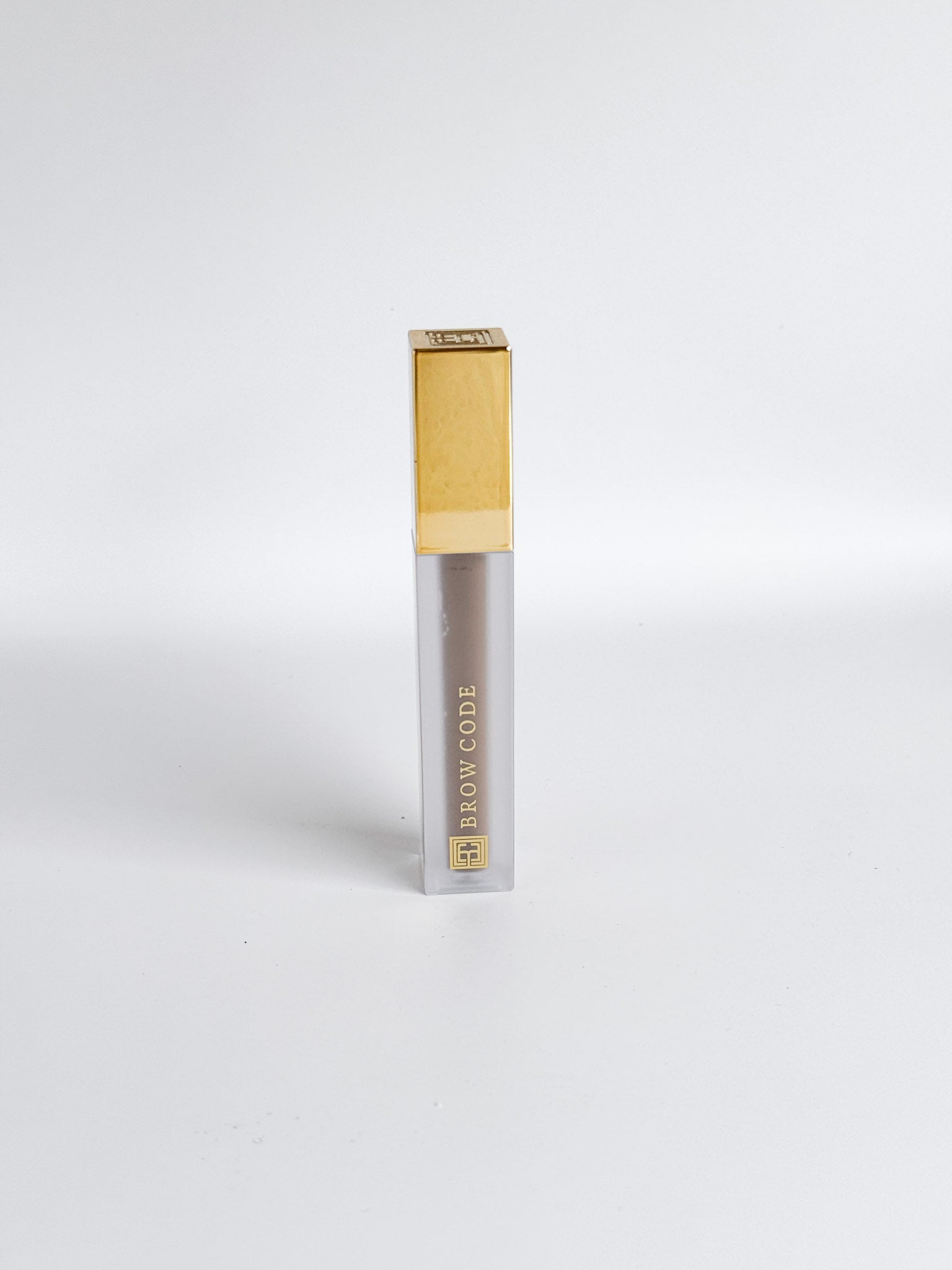 Brow gel product tube with sleek gold packaging