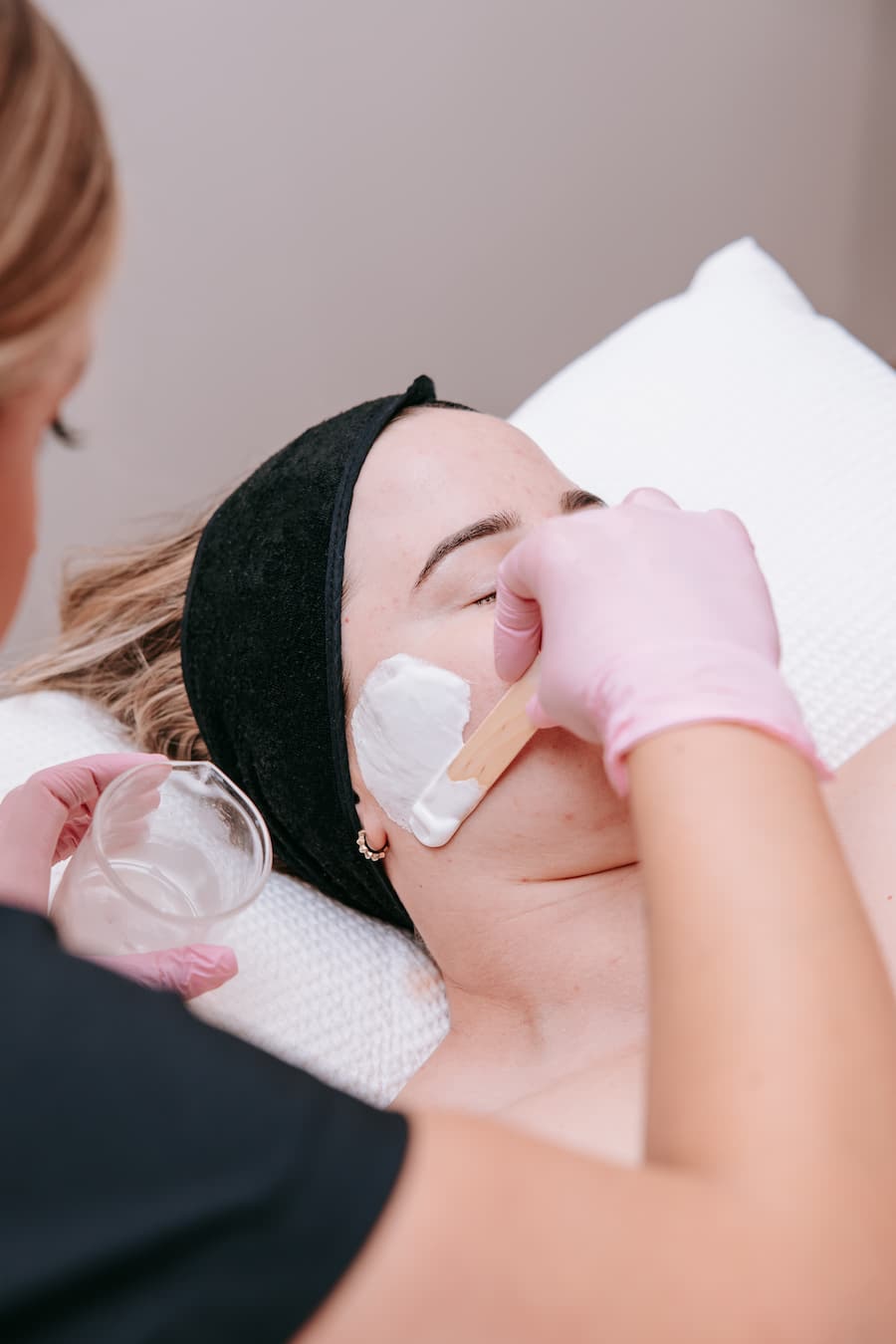 Close-up of TGS therapist applying dermafix conditioning alkaline wash facial mask during professional skin treatment in Perth
