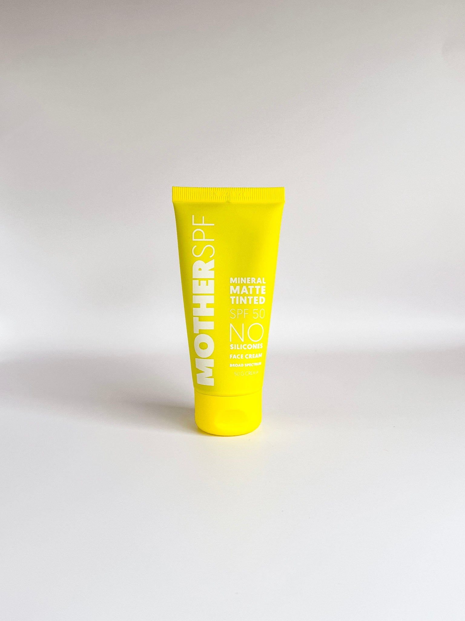 Bright yellow sunscreen tube clearly showing product packaging.