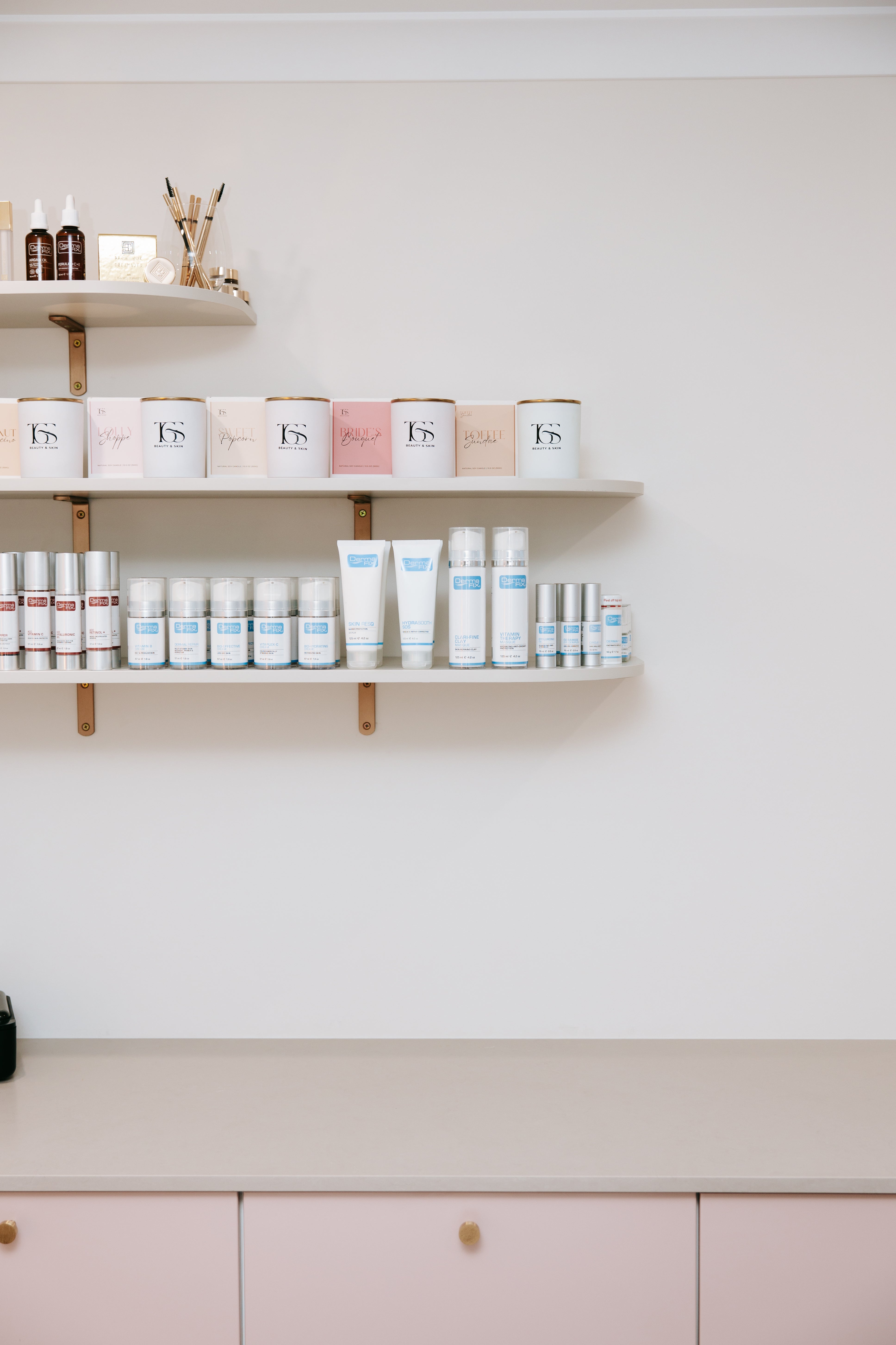 DermaFix skincare and TGS Beauty & Skin candles displayed on salon shelves in Perth