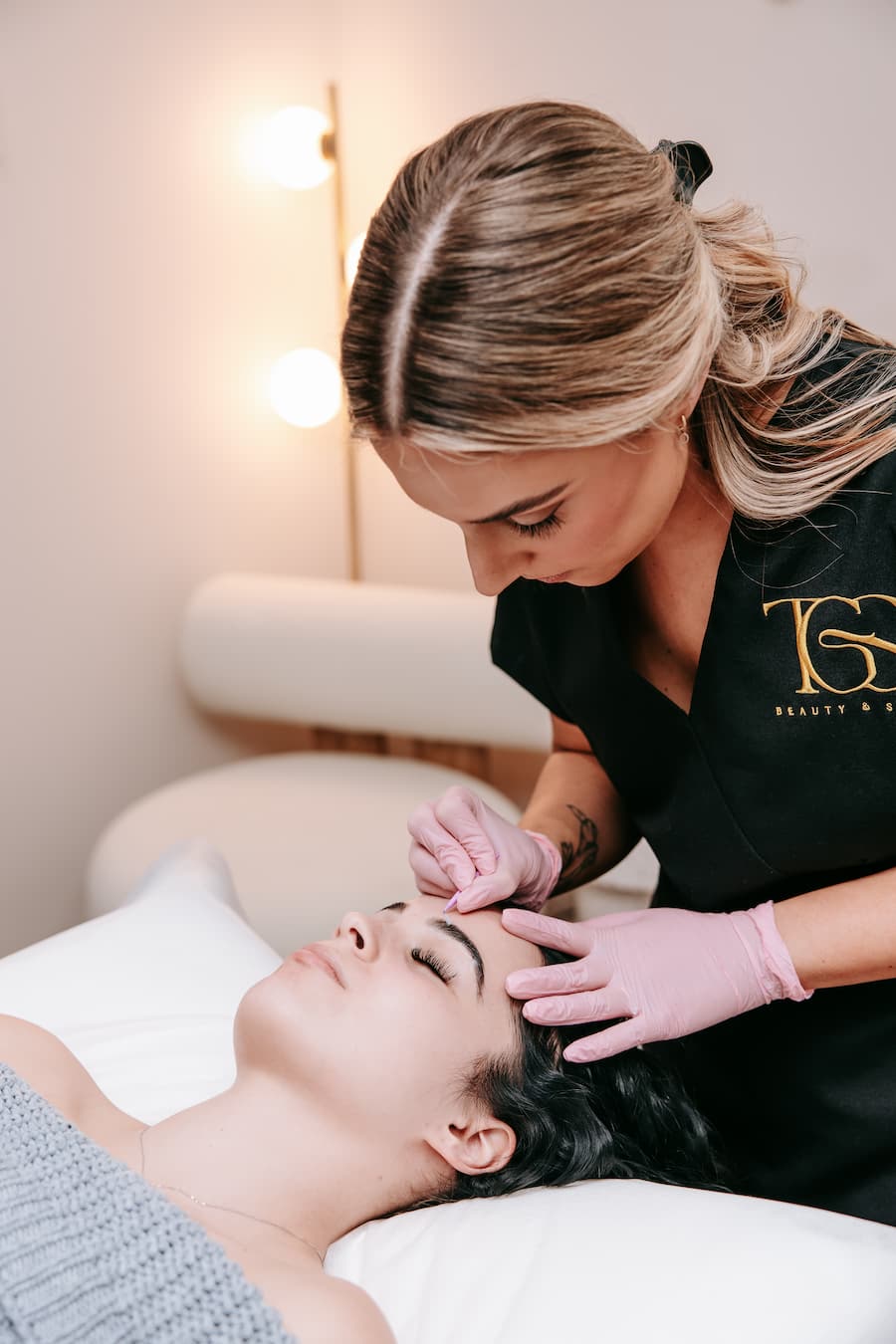 TGS Beauty therapist performing brow lamination as part of bundle service in Hammond Park clinic