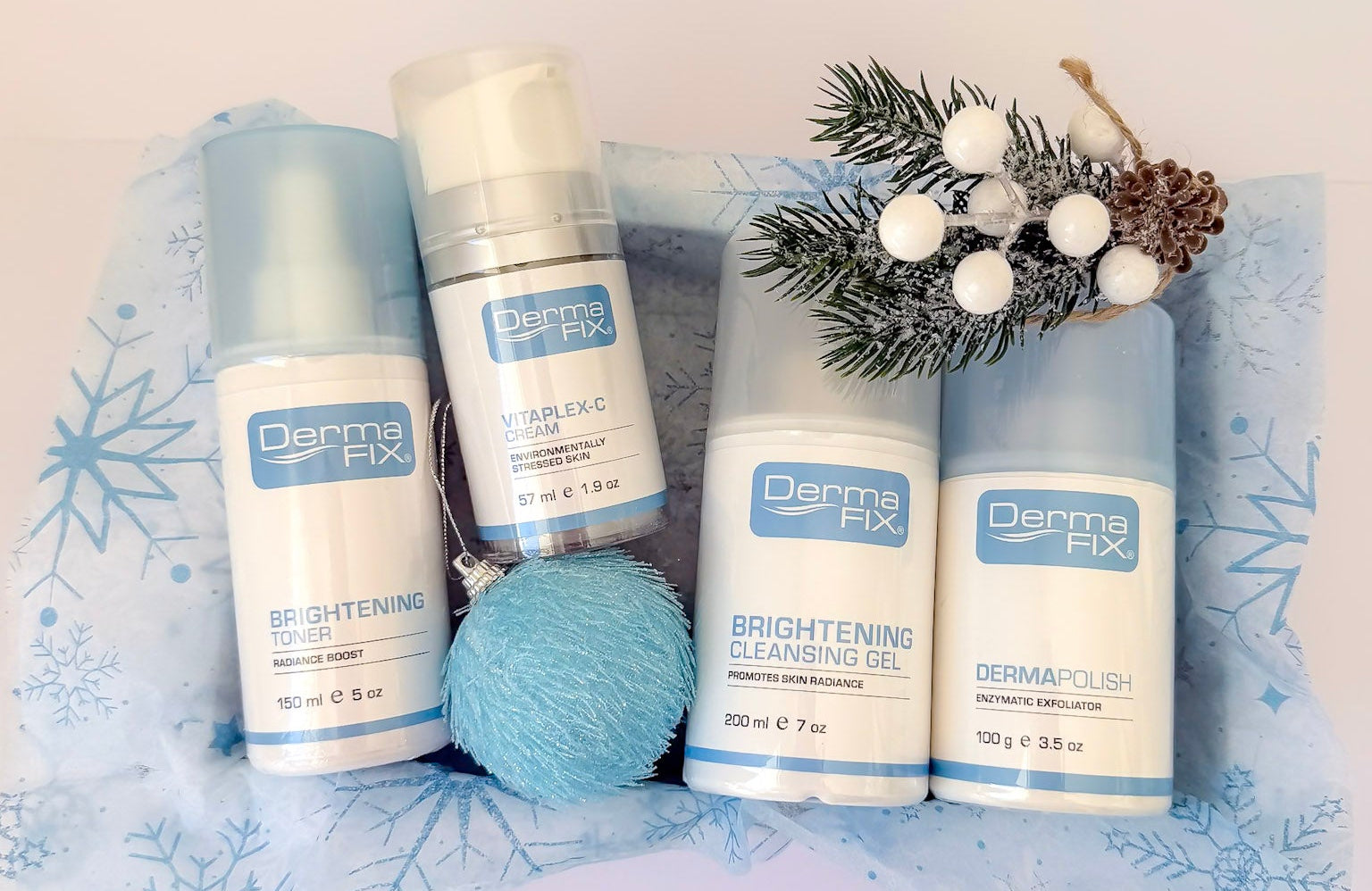 Set of Derma Fix skincare products on a decorative background with snowflakes and a pine branch.