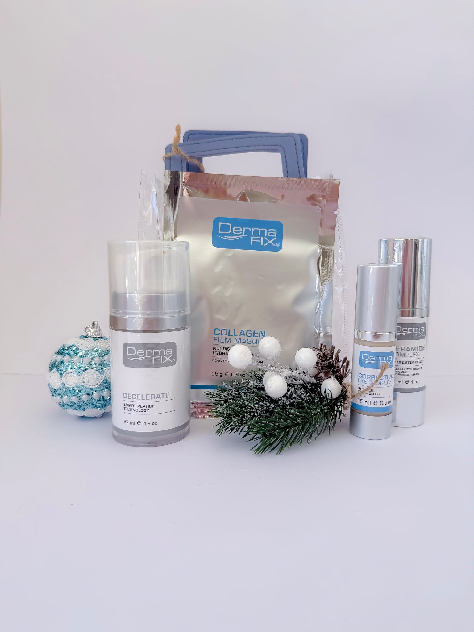 Skincare products with a decorative bag and Christmas tree on a white background