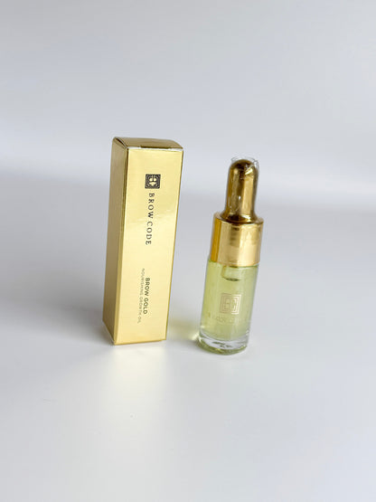 Brow Gold Nourishing Growth Oil dropper dispensing a golden drop of nutrient-rich oil for brow nourishment.