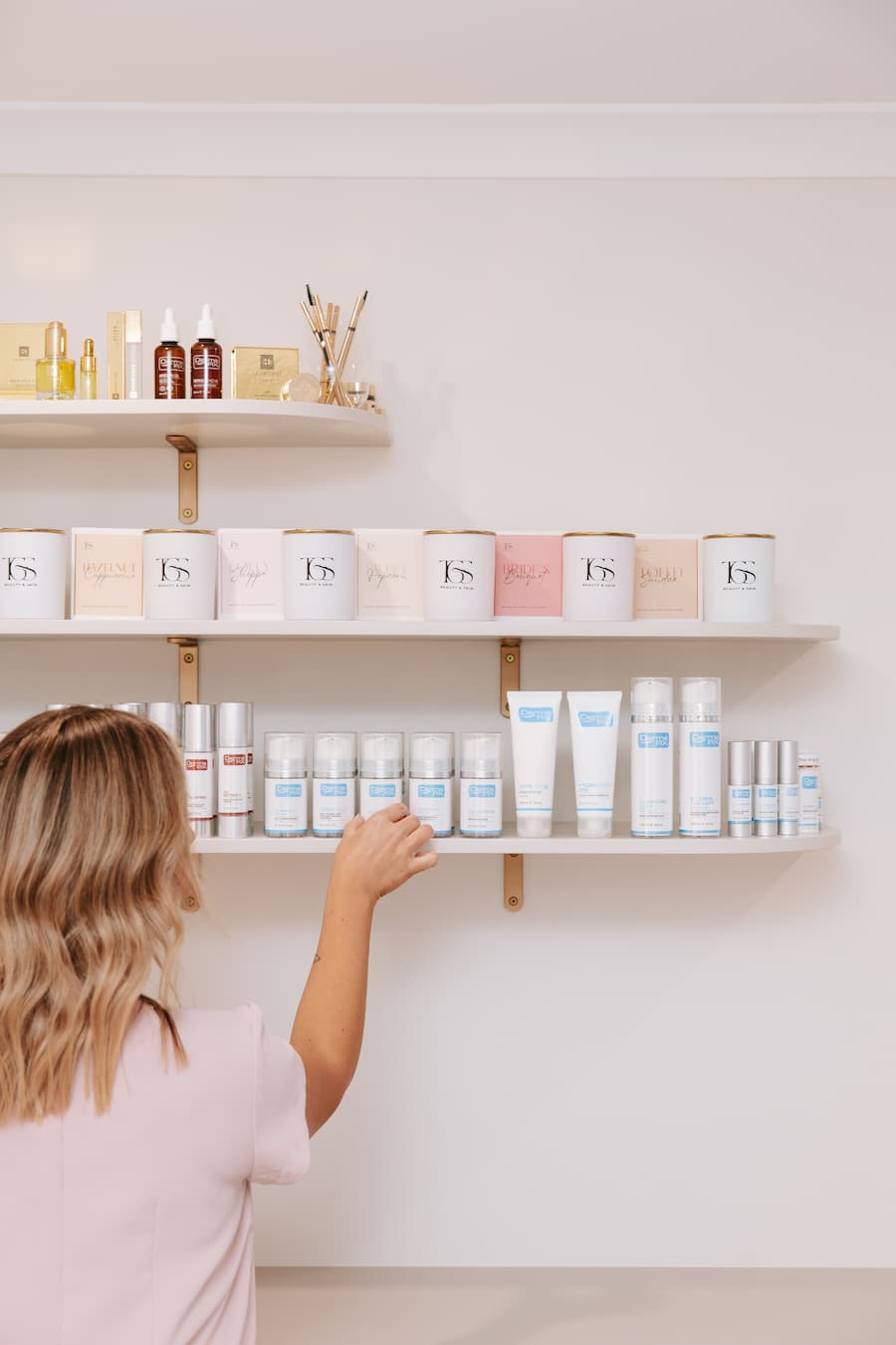 TGS Beauty & Skin product shelf featuring DermaFix corrective skincare and handmade soy candles in Perth