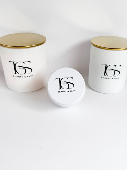  Group of white candles in various sizes with matching gold lids.