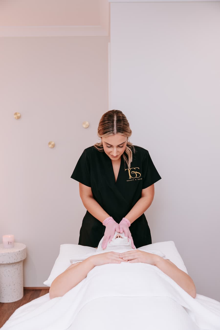 TGS Beauty therapist performing facial treatment in tranquil Hammond Park studio