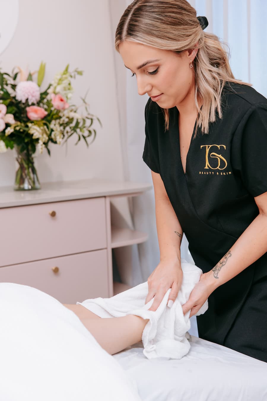 TGS Beauty therapist applying hot towel wrap during Skin Glow Bundle with DermaFix facial in Perth clinic
